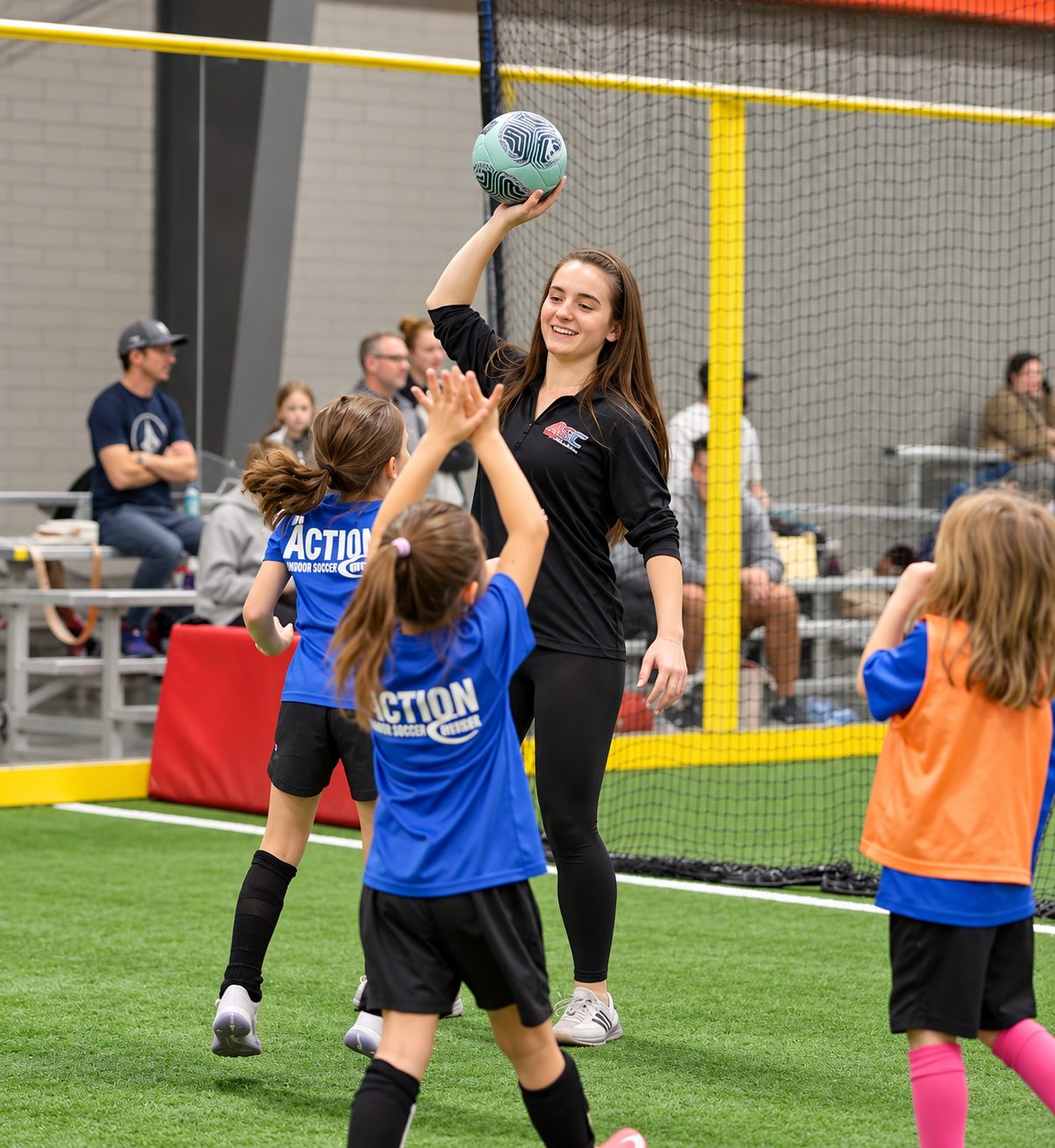 An ASC coach high-fiving young players