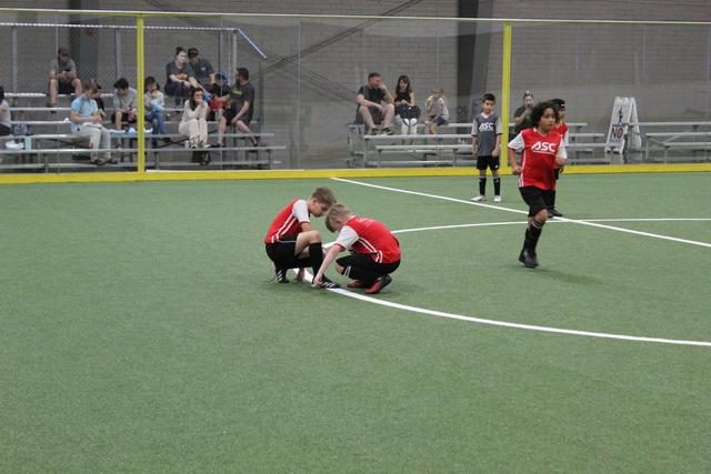 An ASC coach working with a young player